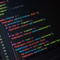 A photo of a screen with Visual Studio Code and some code.